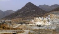 A cloud of dust rises from a dynamite blast, as part of construction work at Ethiopia's Grand Renaissance Dam, March 31, 2015. Reuters/Tiksa Negeri