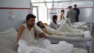 A wounded Afghan police man looks on as he receives treatment following the militants raid that targeted the American University of Afghanistan on August 25, 2016. AFP