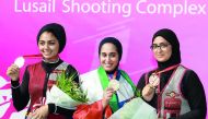 Kuwait’s Eman Alshamaa (centre) winner in the women’s skeet individual event is seen along with Qatar’s Reem Al Sharshani (left) and Sarah Mohamed, second and third place finishers.