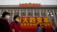 Visitors wear face masks on a polluted day outside an exhibition marking the 40th anniversary of China's reform and opening up at the National Museum of China in Beijing, China November 14, 2018. REUTERS/Thomas Peter