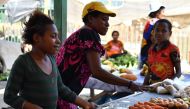 Vendors sell vegetables at a women's only makeshift market on the outskirts of Port Moresby on November 19, 2018, one day after the Asia-Pacific Economic Cooperation (APEC) Summit. AFP / SAEED KHAN