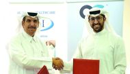 Mohamed Al Hajiri (left), CEO of Al-Jazira Healthcare Group, and Saleh Majid Al Khulaifi, Board Member of Qatari German Medical Devices, exchanging documents after they signed a cooperation agreement in the field of medical manufacturing at a function hel