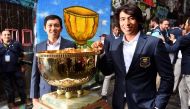 Team Malaysia's Ben Leong (L) and Gavin Green pose with the World Cup of Golf trophy in Melbourne on November 20, 2018.  AFP / William West 