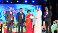 Dr. Khalid bin Mubarak Al-Shafi (second right), the Editor-in-Chief of The Peninsula and the Chief Guest of the 15th Founder’s Day celebrations of Birla Public School (BPS), honours Anu Thomas, Headmistress, Primary Section at BPS, for her 10 years of ded