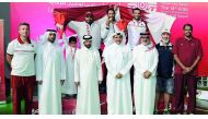 The podium winners at the 14th Arab Shooting Championship pose for a picture with officials at Losail Shooting Range yesterday.
