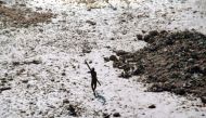 In this handout photo provided by the Indian Coast Guard and Survival International and taken on December 28, 2004, a man with the Sentinelese tribe aims his bow and arrow at an Indian Coast Guard helicopter as it flies over North Sentinel Island in the A