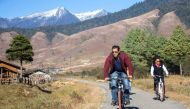 This handout photograph taken and released on November 22, 2018 by the Arunachal Pradesh Department of Information and Public Relations shows Indian Bollywood actor Salman Khan (L) and Indian Union minister of State for Home Affairs Kiren Rijiju (R) ridin