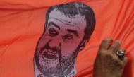 A drawing of Italy’s Interior Minister and deputy PM Matteo Salvini is displayed on a banner during a march as part of the International Day for the Elimination of Violence against Women, on November 24, 2018 in Rome. AFP / Tiziana Fabi 