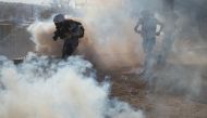 A photojournalist is surrounded in a cloud of tear gas released by U.S. Customs and Border Protection (CBP) after migrants, part of a caravan of thousands from Central America, attempted to illegally cross the border into the United States from Tijuana, M