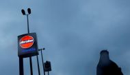 File photo of a woman walking past a logo of Indian Oil outside a fuel station in New Delhi, India, August 29, 2016. REUTERS/Adnan Abidi/File photo