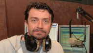 Radio One host Gavin Ford posing in the Lebanese based Radio station in the town of Beit Mery east of Beirut on January 26, 2017. AFP 