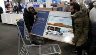 People carry a television inside a Best Buy during a sales event on Thanksgiving day in Westbury, New York, November 22, 2018. Reuters/Shannon Stapleton/