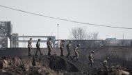 Members of the Chinese military inspect the area after an explosion near a chemical factory in Zhangjiakou, some 200km northwest of Beijing on November 28, 2018. / AFP / FRED DUFOUR