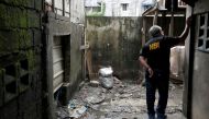 A member of the Philippine National Bureau of Investigation inspects the site where Kian Lloyd delos Santos, a 17-year-old student, was killed during anti-drug operations in Caloocan, Metro Manila, Philippines August 23, 2017. Reuters/Erik De Castro