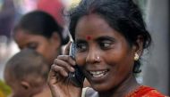 An Indian slum dweller uses a mobile phone in the eastern Indian city of Kolkata, August 23, 2005 (Reuters) 