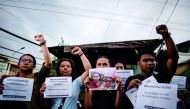 Supporters of Kian delos Santos protest outside the police station where three policemen involved in Kian's killing were assigned in Manila on November 29, 2018.  AFP / Noel Celis
