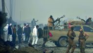 Afghan security forces and investigators gather at the site of a suicide bomb attack outside a British security firm's compound in Kabul, a day after the blast on November 29, 2018.  AFP / Noorullah Shirzada

