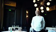 French chef Guy Savoy poses in the dining room of his Michelin three-starred restaurant 
