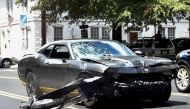 In this file photo taken on August 12, 2017, the Dodge Charger allegedly driven by James Alex Fields Jr. passes near the Market Street Parking Garage moments after driving into a crowd of counter-protesters on Water Street in Charlottesville, Virginia. / 