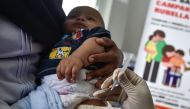 (FILES) In this file photo taken on September 19, 2018 a medical worker injects a baby with a measles-rubella (MR) vaccine at a health station in Banda Aceh in Aceh province. AFP / CHAIDEER MAHYUDDIN