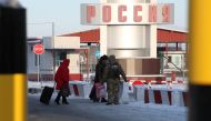 A member of the Ukrainian State Border Guard Service accompanies women who were denied entry to the country at the Goptovka crossing point on the border between Russia and Ukraine in Kharkiv Region, Ukraine November 30, 2018. REUTERS/Vyacheslav Madiyevsky
