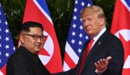 File photo of US President Donald Trump (R) gestures as he meets with North Korea's leader Kim Jong Un (L) at the start of their historic US-North Korea summit, at the Capella Hotel on Sentosa island in Singapore on June 12, 2018.  / AFP / SAUL LOEB