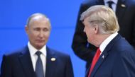 US President Donald Trump (R) looks at Russia's President Vladimir Putin as they take their places for a family photo, during the G20 Leaders' Summit in Buenos Aires, on November 30, 2018. AFP / Alexander NEMENOV