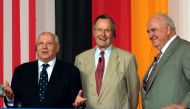 Former US President George Bush (C) flanked by former Soviet leader Mikhail Gorbachev (L) and former German Chancellor Helmut Kohl (R) stand together during a visit in Geisa at the border between Thuringia and Hesse, central Germany on June 17, 2005. AFP 