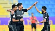 Al Sadd’s Akram Afif, Baghdad Bounedjah and skipper Hassan Al Haydos celebrate after the Algerian striker scored one of his three goals against Al Gharafa at the Al Gharafa Stadium yesterday. 