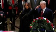 US President Donald Trump and First Lady Melania Trump arrive to pay their respects to former US President George H. W. Bush as he lies in state in the US Capitol's rotunda December 3, 2018 in Washington, DC. / AFP / POOL / JONATHAN ERNST 
