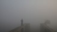 A man walks on the banks of the Yamuna River during a foggy morning in the old quarters of Delhi, India, December 4, 2018. REUTERS/Anushree Fadnavis