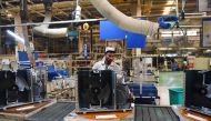 This photograph taken on November 23, 2018 shows an Indian worker on the production line in the Daikin air conditioning plant in Neemrana, about 120km southwest of the Indian capital New Delhi. AFP / Money SHARMA 