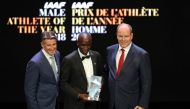 Kenyan athlete Eliud Kipchoge poses next to president of the International Association of Athletics Federations (IAAF) Sebastian Coe and Prince Albert II of Monaco after receing the Male athlete of the year award during the IAAF athlete of the year awards