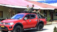 Indonesian Mobile Brigade Police head to Nduga, where 31 construction workers are believed to have been shot dead, from Wamena on December 4, 2018. / AFP / ANYONG 