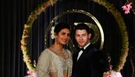 Indian Bollywood actress Priyanka Chopra (L) and US musician Nick Jonas, who were recently married, pose for a photograph during a reception in New Delhi on December 4, 2018. AFP / SAJJAD HUSSAIN