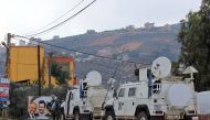 United Nations Interim Forces in Lebanon (UNIFIL) vehicles and armoured personnel carriers (APC) are seen on a road near the border between the southern Lebanese village of Kfar Kila and Israel on December 4, 2018 AFP / Ali DIA
