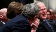 George W. Bush smiles with his brother Jeb Bush at the State Funeral for their father George H.W. Bush, at the National Cathedral, Wednesday, Dec. 5, 2018, in Washington. Alex Brandon/ via Reuters