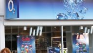 FILE PHOTO: A woman speaks on her mobile telephone outside an O2 shop in Loughborough, central England January 23, 2015. REUTERS/Darren Staples