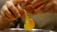A pastry chef breaks an egg as she prepares to bake a cake at a bakery in Seoul, December 22, 2016. Reuters / Kim Hong-Ji