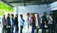 Indian men stand in queue to cast their vote at a local polling station during Rajasthan's Legislative Assembly election, in Jodhpur on December 7, 2018. AFP / Chandan Khanna
