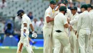 India's captain Virat Kohli (L) walks as Australia's team celebrates his wicket during day three of the first Test cricket match at the Adelaide Oval on December 8, 2018. (AFP / Peter PARKS)