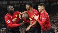 Manchester United's English striker Marcus Rashford celebrates with teammates after scoring their fourth goal during the English Premier League football match between Manchester United and Fulham at Old Trafford in Manchester, north west England, on Decem