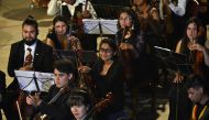 Bolivian coca grower Mariel Chura (C) 21, waits to play the viola during a presentation of the Youth Symphonic Orchestra of Chulumani, some 120 km north of La Paz, on November 21, 2018. Chura joined the Youth Symphonic Orchestra of Chulumani at the age of