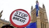 Anti-Brexit protesters wave flags and placards opposite the Houses of Parliament in London, Britain, December 10, 2018. REUTERS/Toby Melville