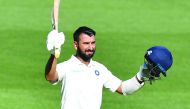 India’s Cheteshwar Pujara celebrates after scoring his century during day one of the first Test at the Adelaide Oval in Adelaide, Australia, in this December 6, 2018, file photo.