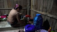 This photo taken on October 2, 2018 shows Nary, a Cambodian victim of forced marriage to a Chinese man, cooking at home in Phnom Penh. AFP / TANG CHHIN Sothy 