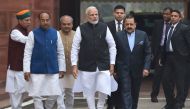 Indian Prime Minister Narendra Modi (C) walks upon his arrival for the winter session of parliament in New Delhi on December 11, 2018. / AFP / Money SHARMA
 