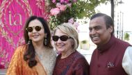 Former U.S. Secretary of State Hillary Clinton poses with Mukesh Ambani, Chairman of Reliance Industries, and his wife Nita Ambani after her arrival in Udaipur to attend pre-wedding celebrations of their daughter Isha Ambani in the desert state of Rajasth