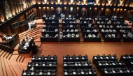 Members of parliament attend a parliament session at Sri Lanka's parliament hall in Colombo on December 12, 2018.  AFP / LAKRUWAN WANNIARACHCHI