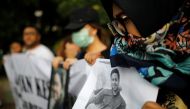 A woman holds a picture of a relative, one of the 189 people killed in a Lion Air plane crash, during a rally calling for Lion Air to put safety over profit and for Indonesian President Joko Widodo to ensure all remains were recovered, in Jakarta, Indones